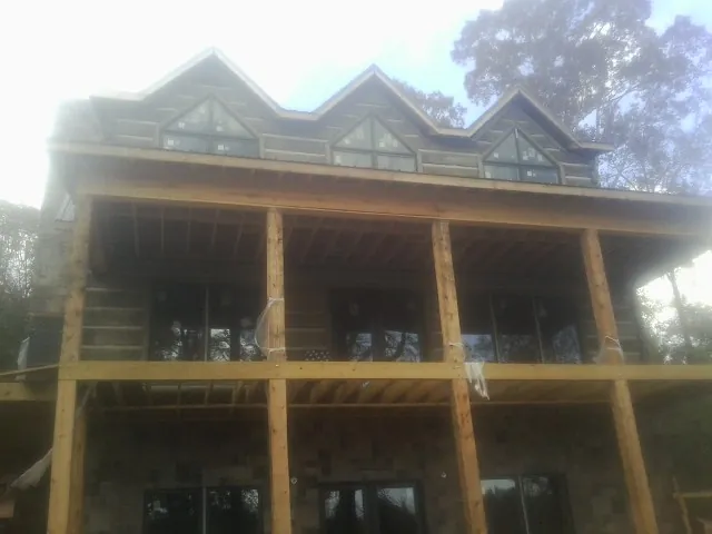 Dormers and porch framing on a large log home under construction in Rawlins